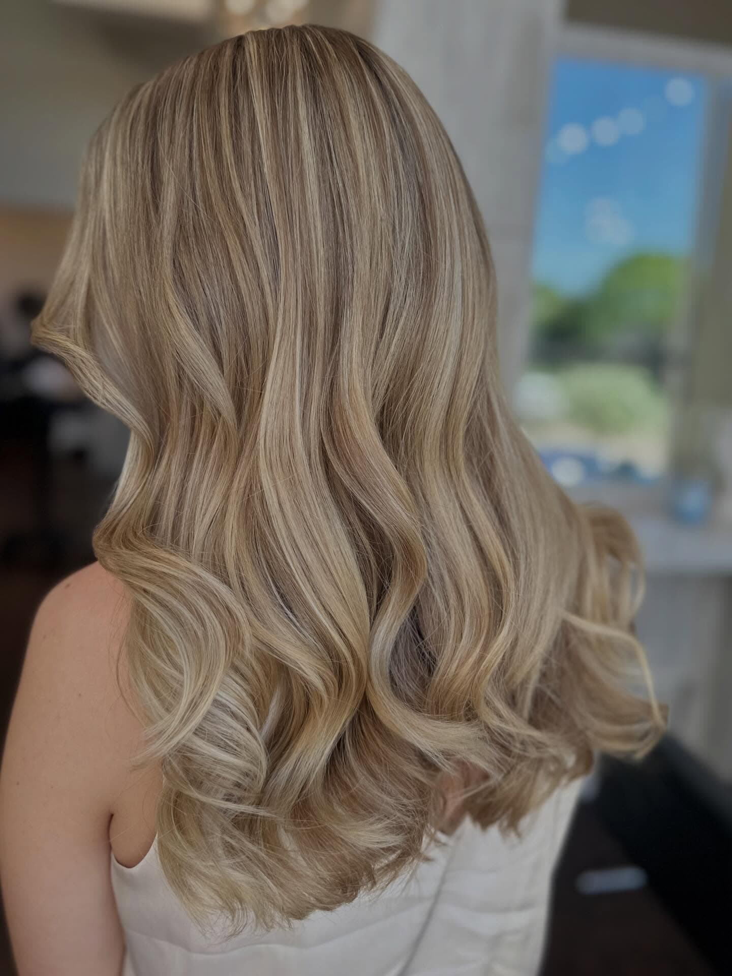 Long layered cut with soft waves and blended ends, finished in-salon at Lee Graves Salon in Plano, TX