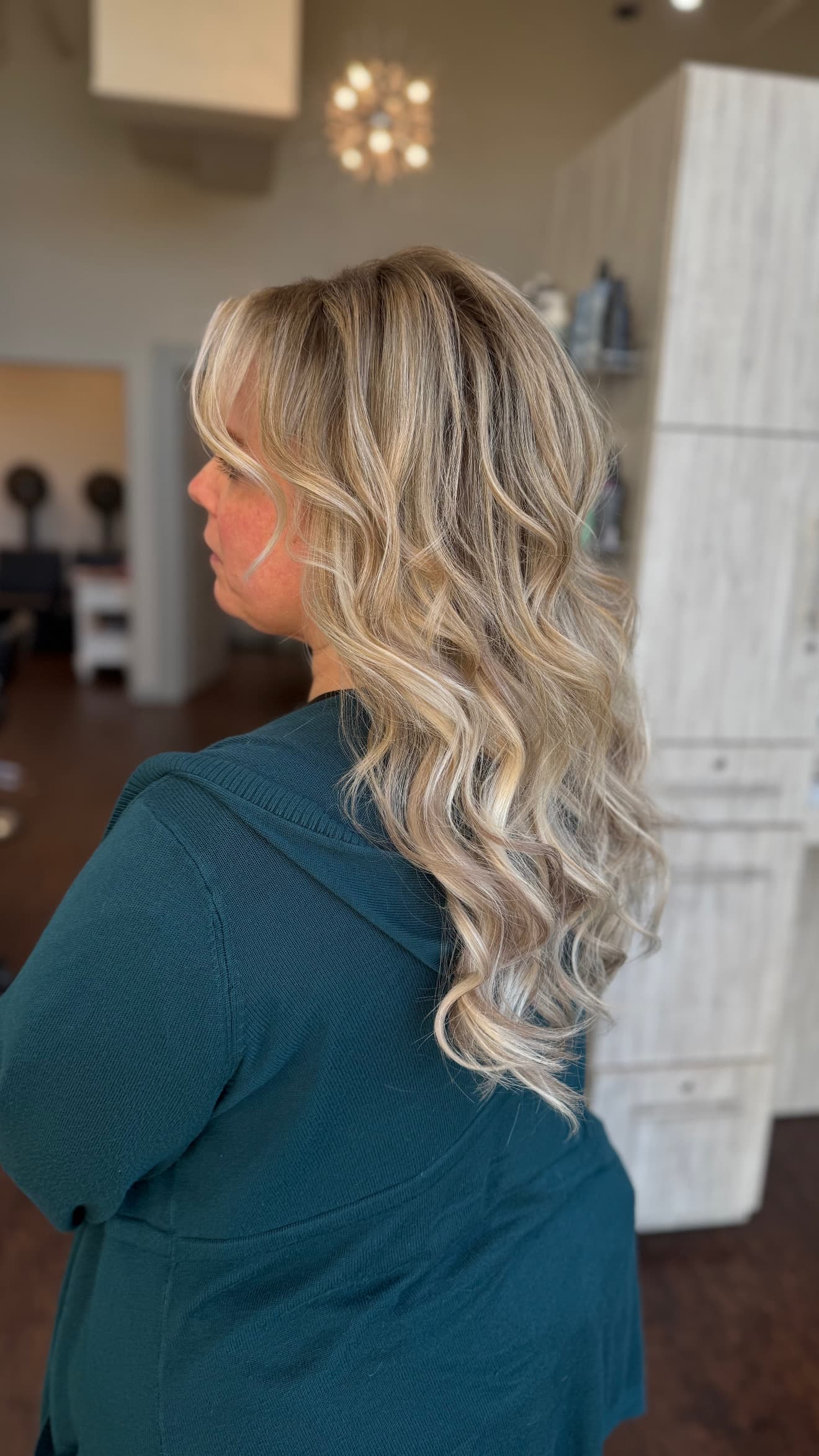 Dimensional blonde hair with a smooth cuticle and defined waves at Lee Graves Salon in Plano, TX