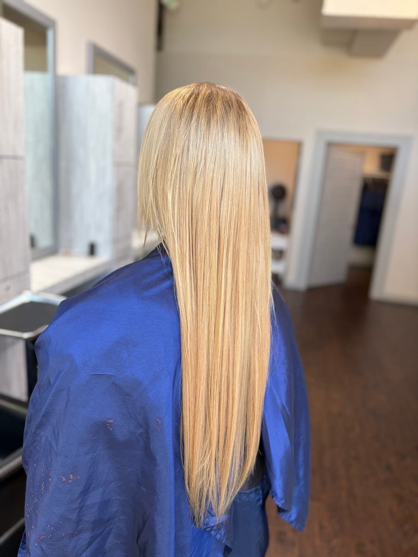 Long hair pressed straight to a glass-smooth, high-shine finish at Lee Graves Salon in Plano