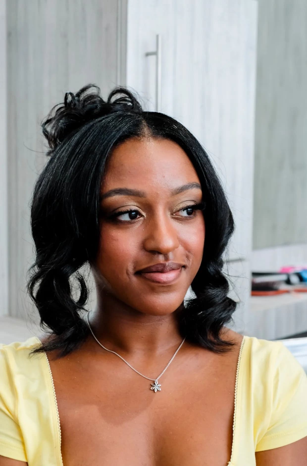 Shoulder-length defined curls with the top section pinned up, styled by the Lee Graves Salon team
