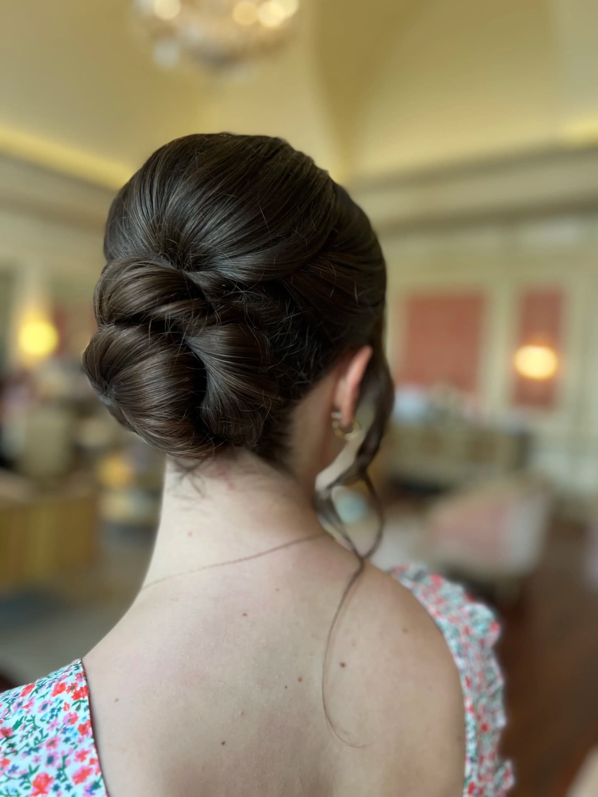 A low twisted chignon finished for a wedding by Something Blue by Lee Graves