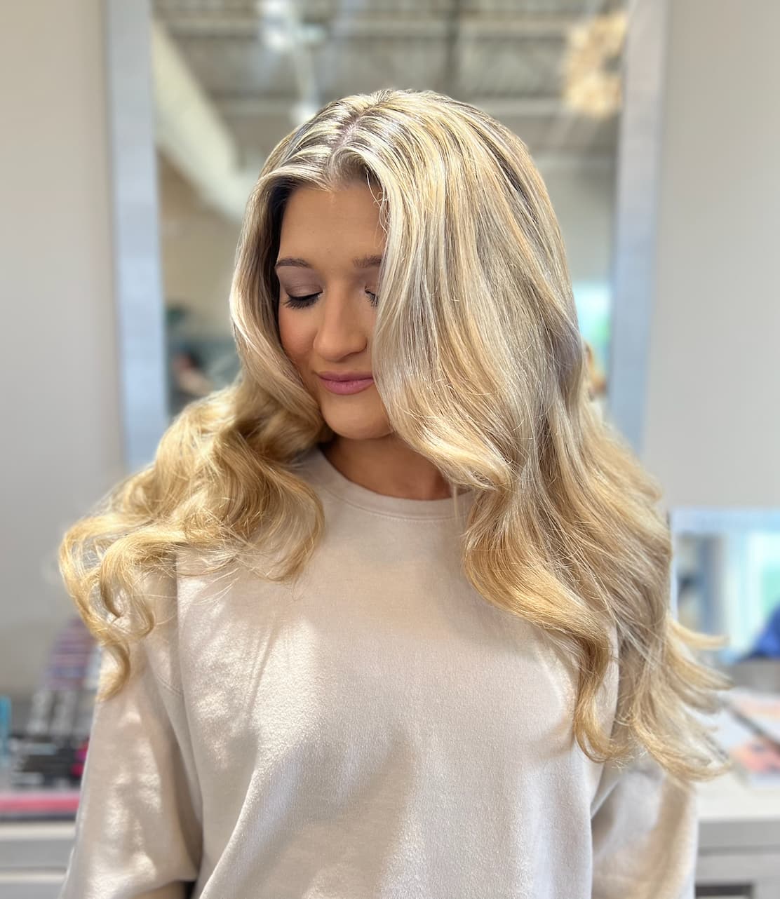 Big, brushed-out glam waves on long blonde hair, styled by the Lee Graves Salon team