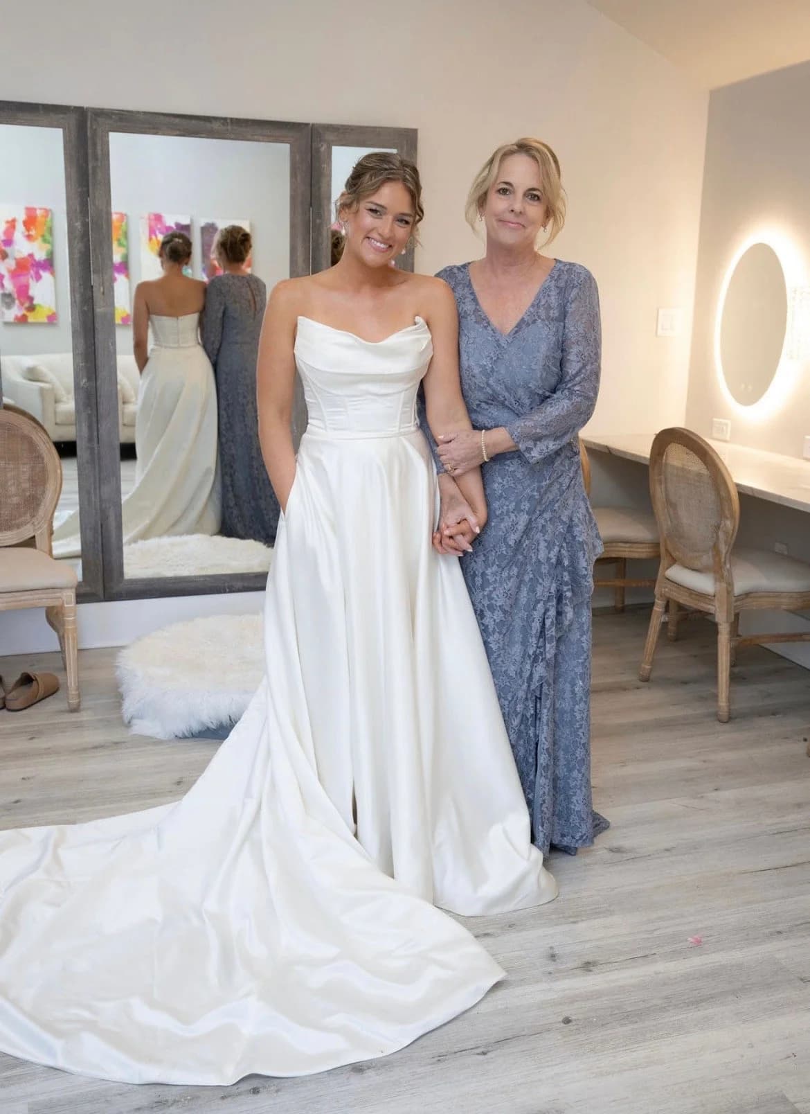 A bride and her mother in a getting-ready suite with hair finished by Something Blue by Lee Graves