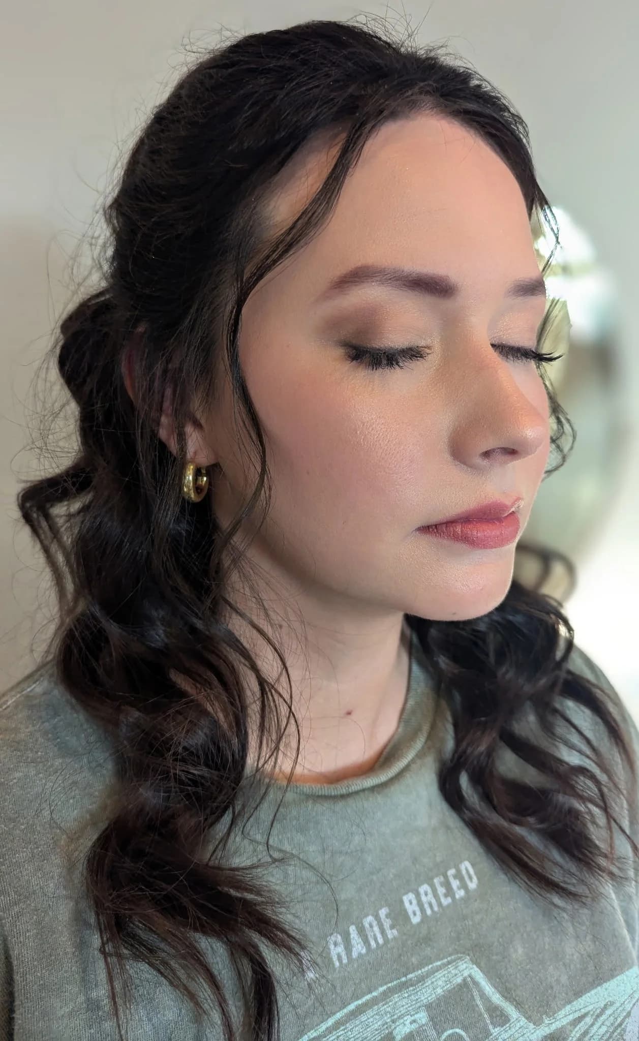 Profile view of finished makeup showing a clean, natural brow arch, by the Lee Graves Salon team