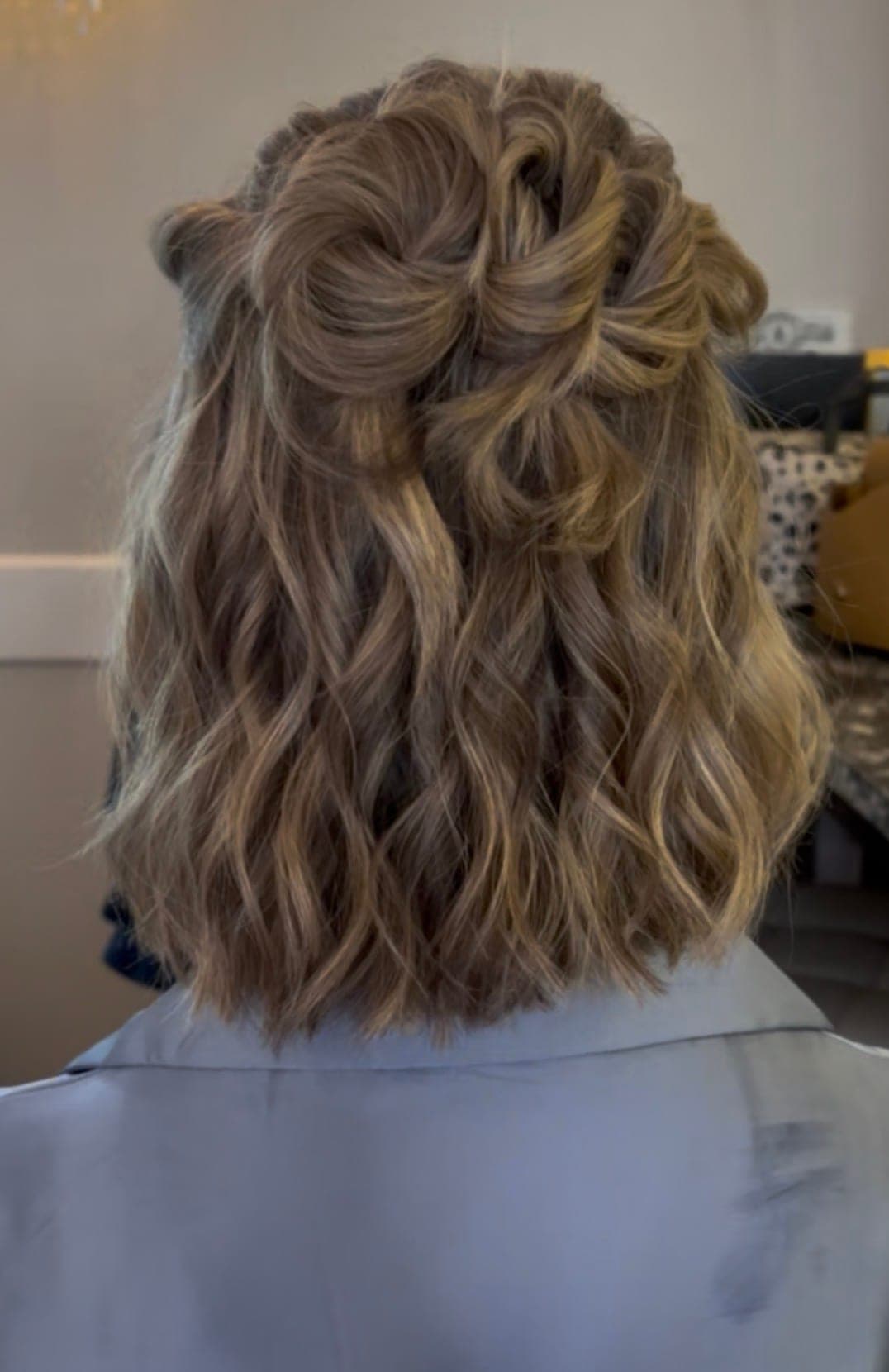 Small half-up knot over shoulder-length textured waves