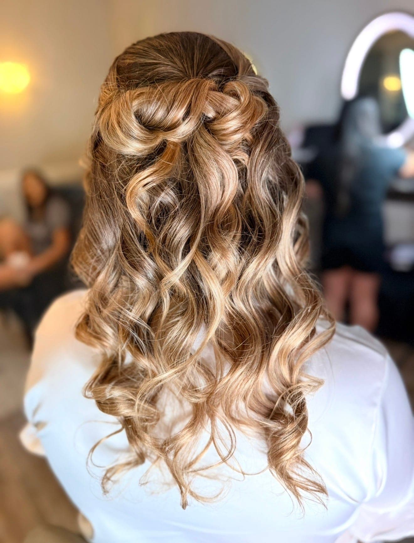 Half-up twist pinned at the crown over long, bouncy curls, styled by the Lee Graves Salon team