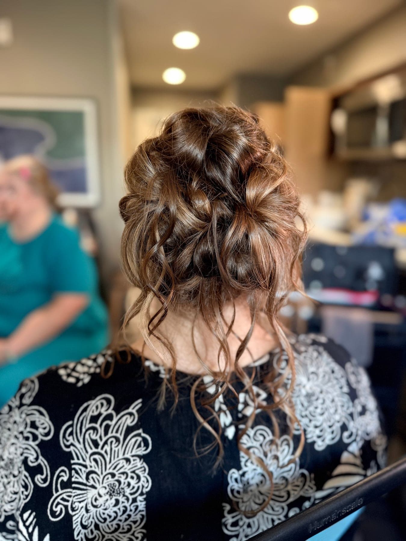 Loose, textured updo with pinned curls and soft pieces left free at the nape, styled by the Lee Graves Salon team