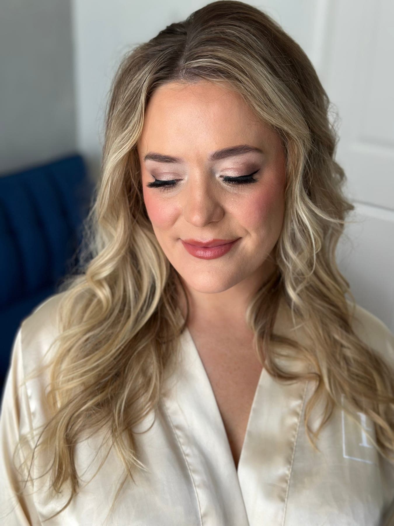 Close-up of a client with full lash extensions and soft glam makeup, eyes closed, at Lee Graves Salon in Plano, TX